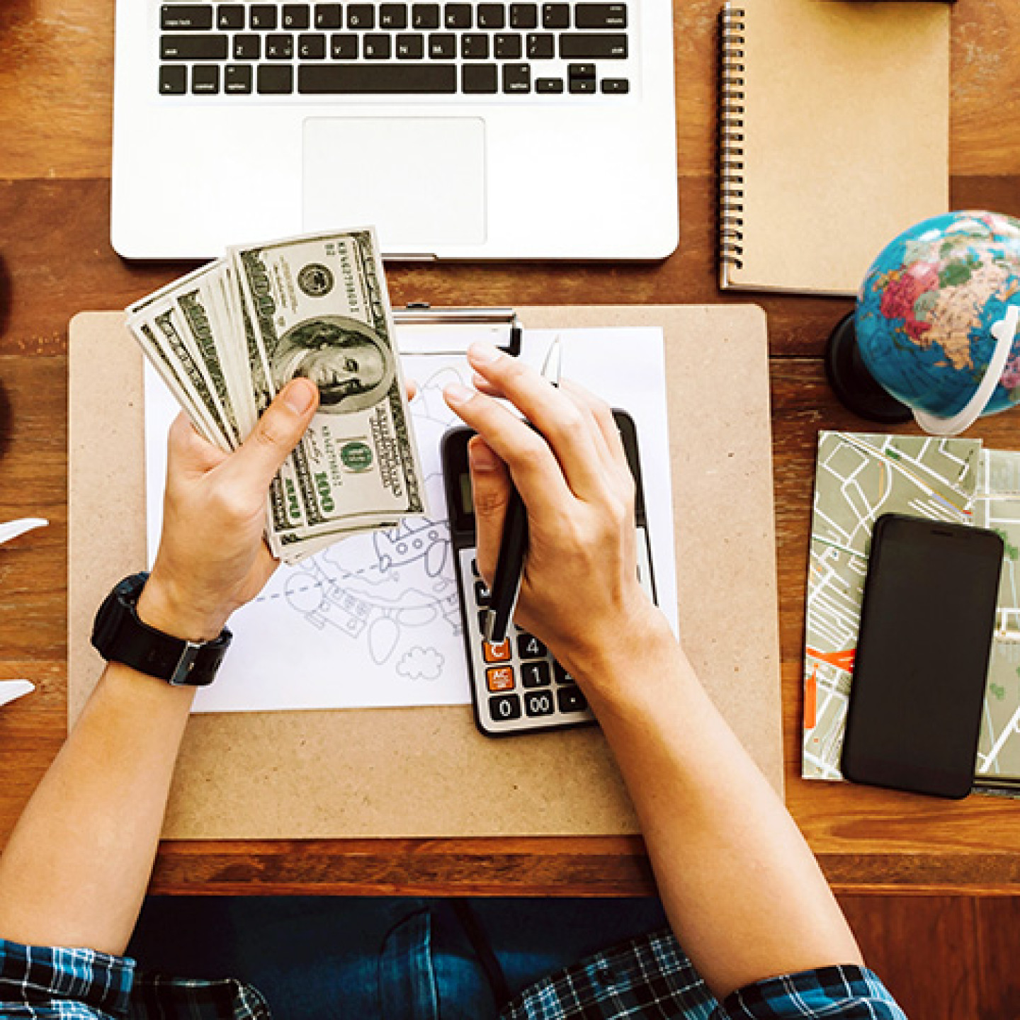 Top view tourist counting cash to spend during his luxury vacati